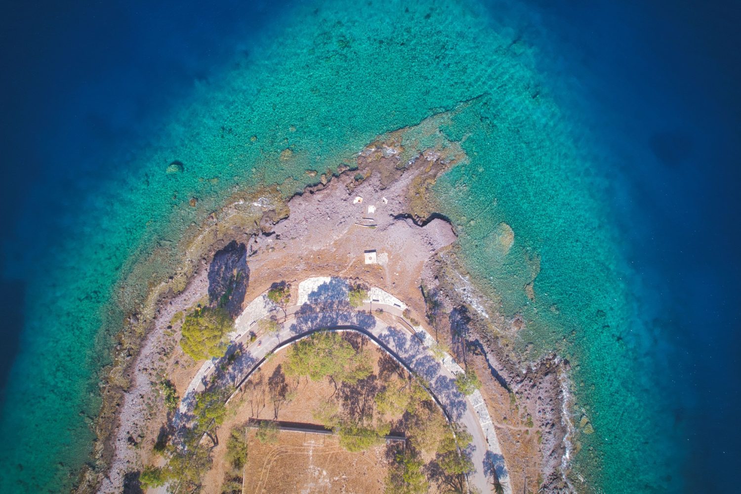 Top view of a road along the sea coast on a sunny day at Aegina island